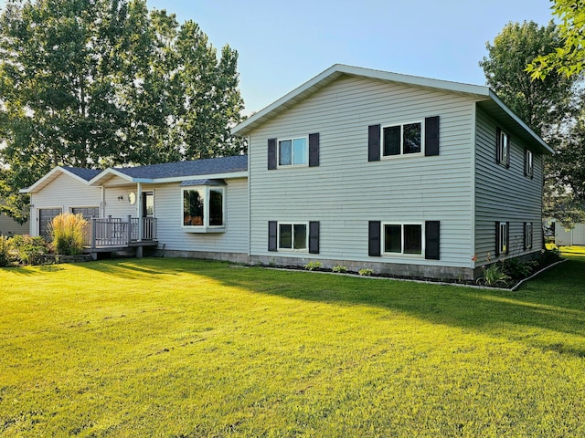 rear view of house featuring a deck and a lawn