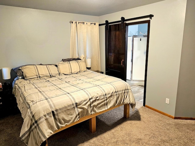 bedroom with carpet flooring and a barn door