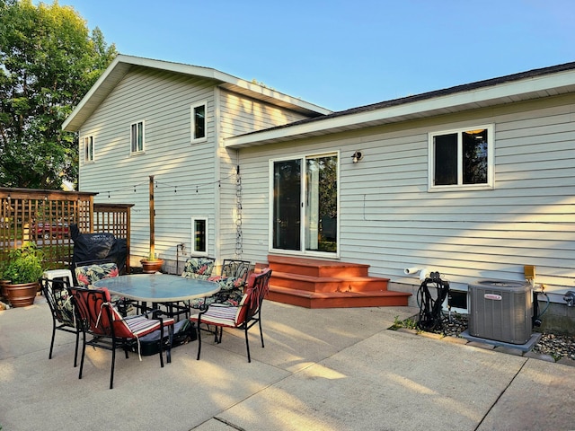 back of house featuring central AC unit and a patio area