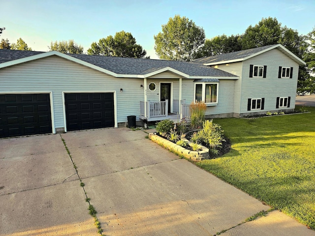 view of front of house with a porch, a garage, and a front yard