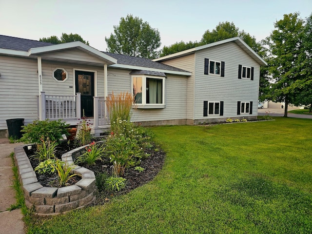 tri-level home with a front yard