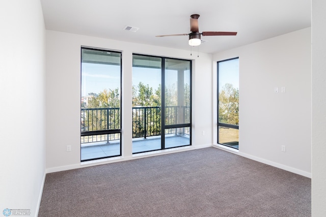 carpeted spare room featuring ceiling fan