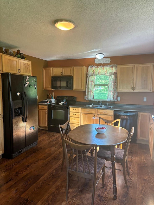 kitchen featuring a textured ceiling, dark hardwood / wood-style floors, sink, and black appliances