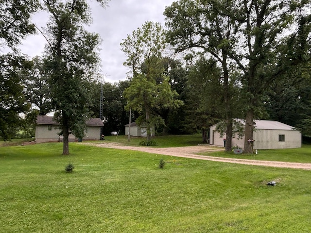 view of yard with an outdoor structure and a garage