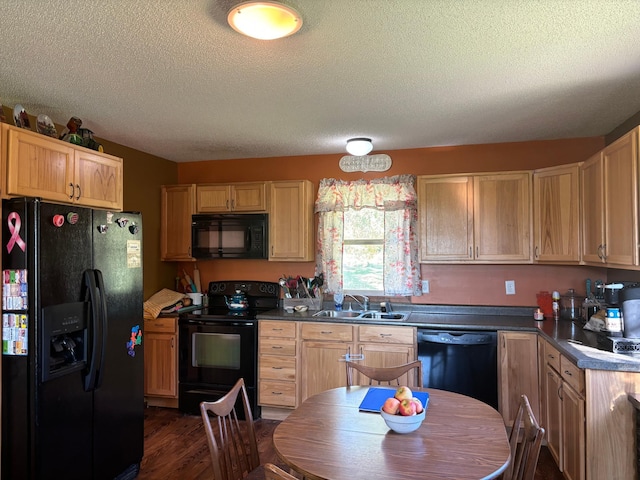 kitchen with dark wood-type flooring, light brown cabinets, a textured ceiling, black appliances, and sink