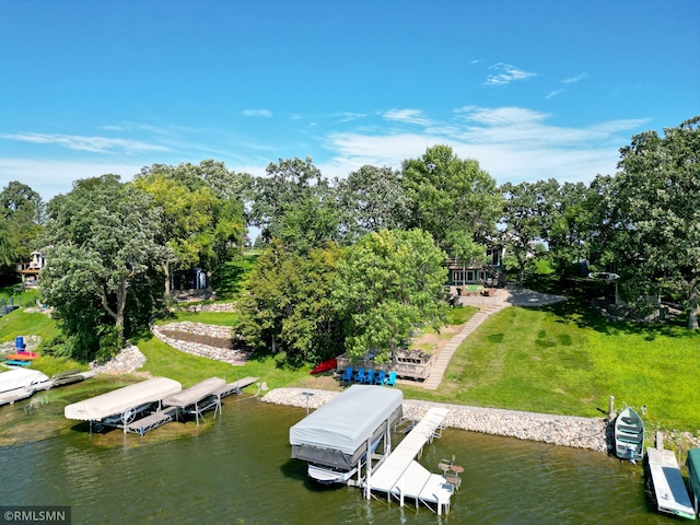 dock area featuring a water view, a yard, and boat lift