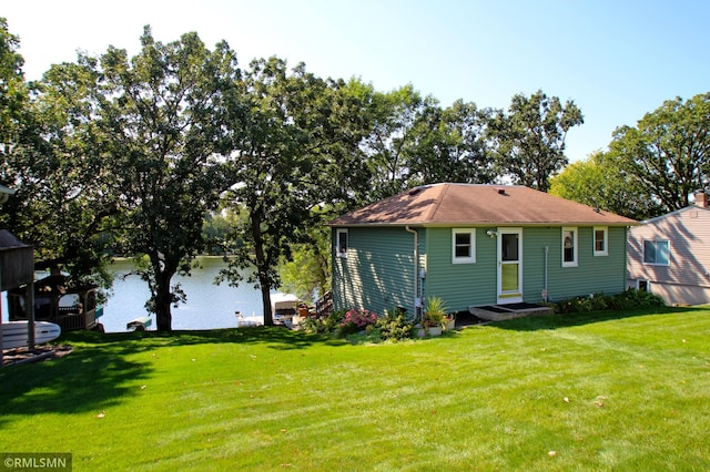 rear view of property with a lawn