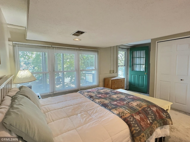 bedroom with a closet, carpet, and visible vents