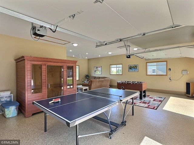 recreation room with a garage and speckled floor