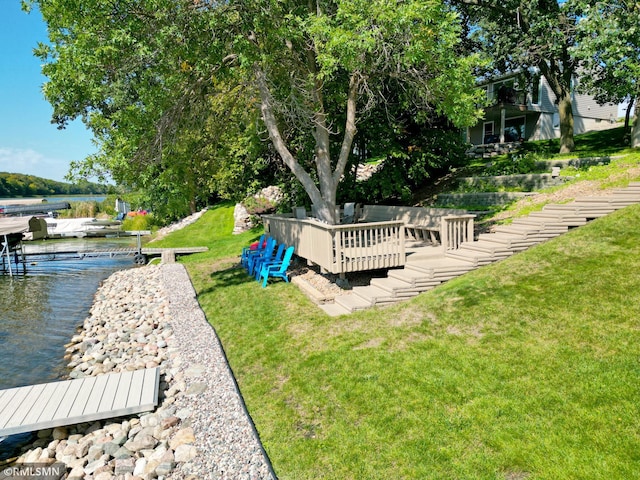 view of yard with a dock and a water view