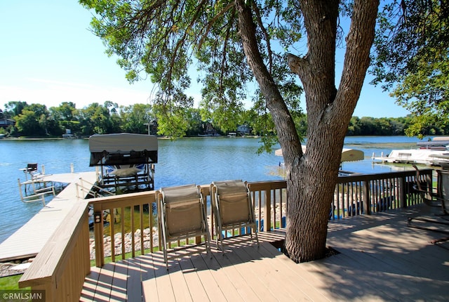 deck featuring a dock, a water view, and boat lift