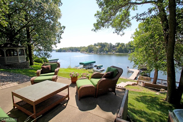 view of patio / terrace featuring a water view, a boat dock, and a gazebo