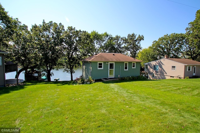 rear view of house featuring a yard