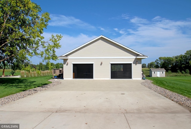 garage featuring a lawn