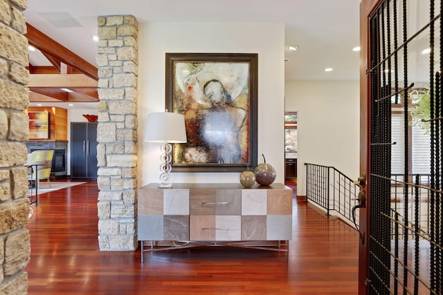 hallway featuring beamed ceiling and hardwood / wood-style flooring