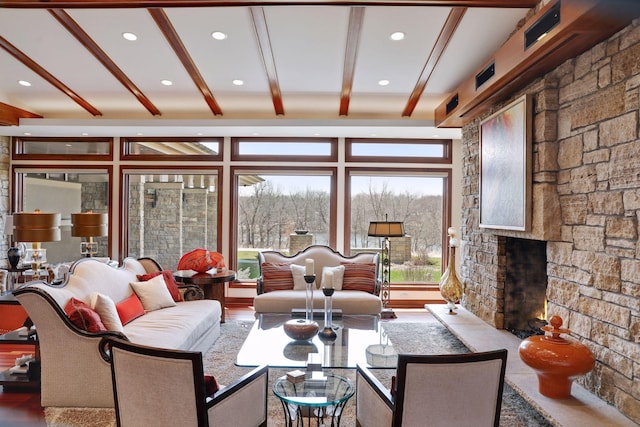 living room featuring wood-type flooring, a fireplace, and beam ceiling