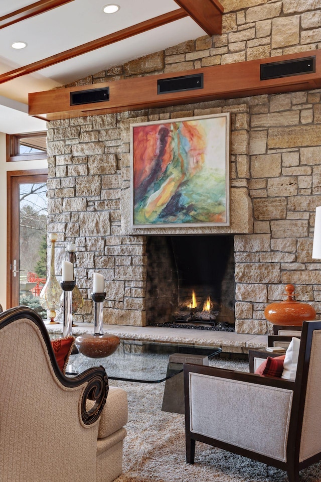 carpeted living room with vaulted ceiling with beams and a fireplace