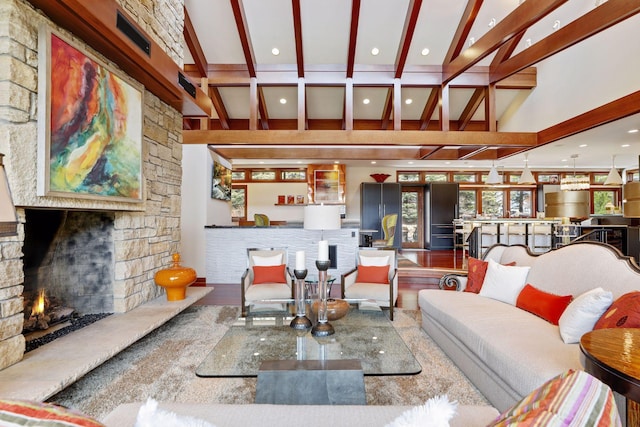 living room with vaulted ceiling with beams, a fireplace, and hardwood / wood-style floors