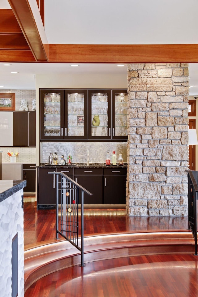 kitchen featuring decorative backsplash and dark hardwood / wood-style floors