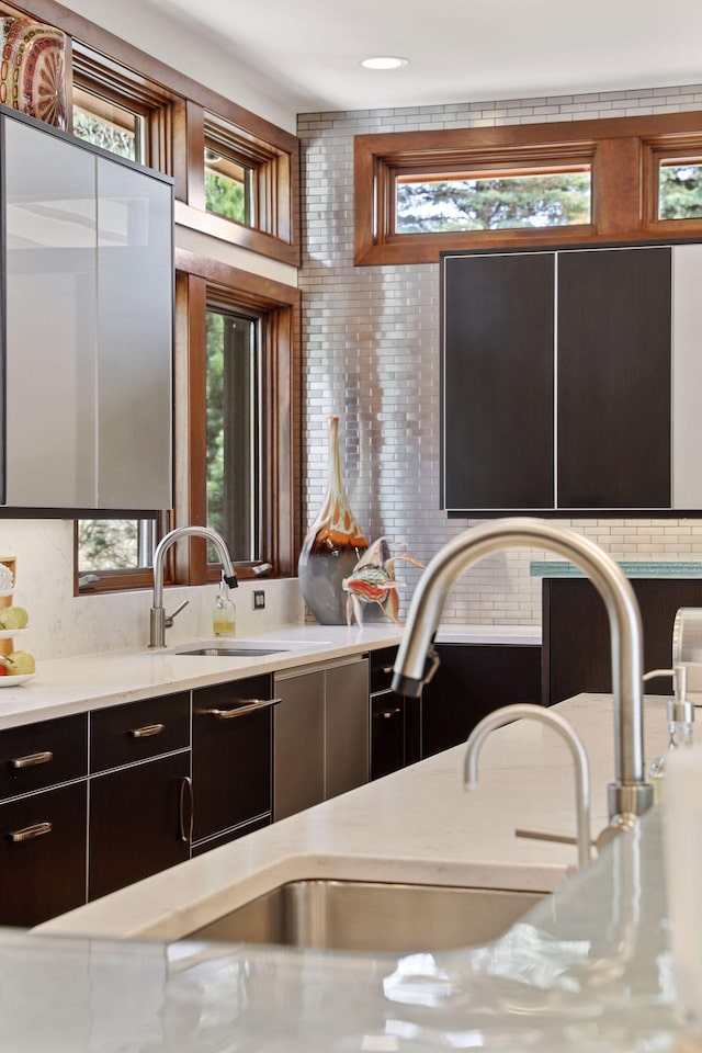 kitchen featuring backsplash, sink, and plenty of natural light