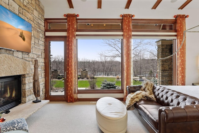 living room featuring ceiling fan, a fireplace, carpet flooring, and a healthy amount of sunlight