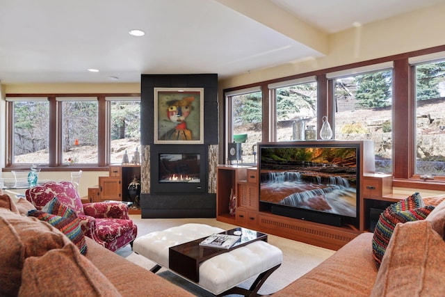 living room with carpet, a fireplace, and a wealth of natural light