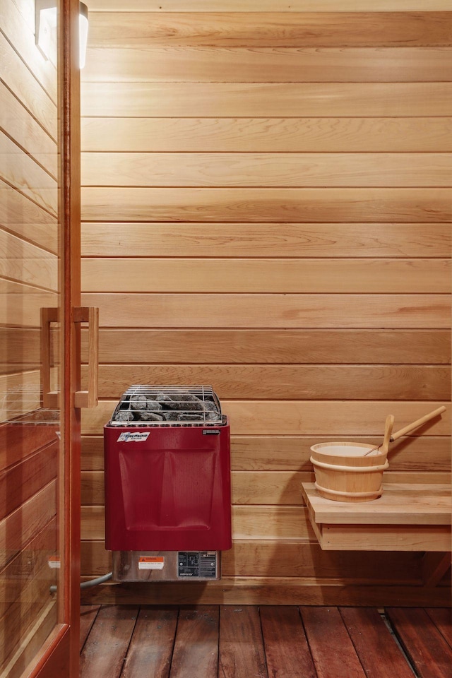 view of sauna / steam room featuring wood-type flooring and wood walls