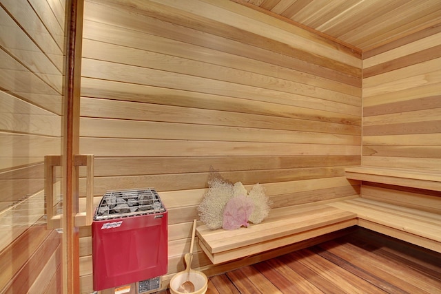 view of sauna featuring wood ceiling and wooden walls