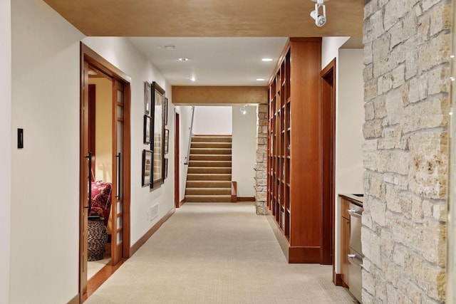 hallway featuring light carpet