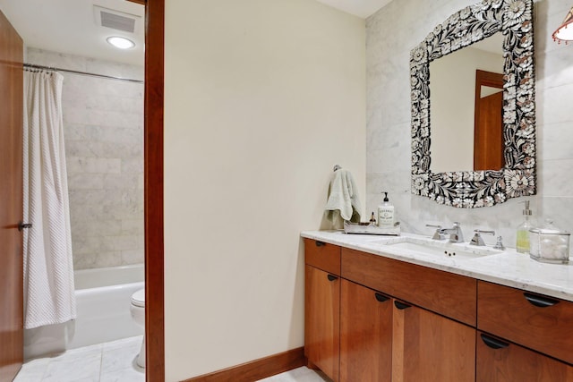 full bathroom featuring tile patterned flooring, vanity, toilet, and shower / bath combination with curtain