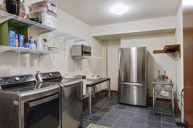 laundry area featuring washing machine and clothes dryer