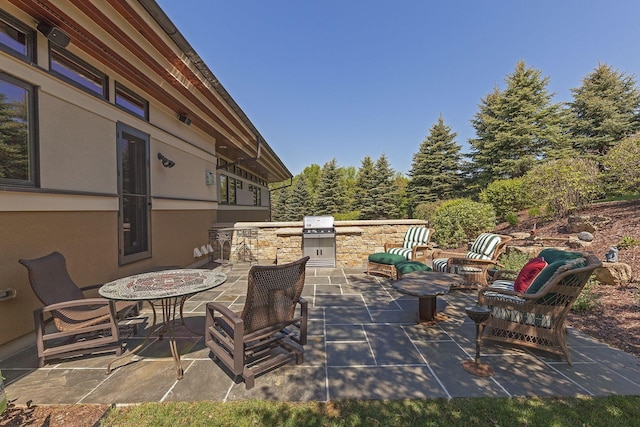 view of patio featuring an outdoor fire pit, a grill, and exterior kitchen