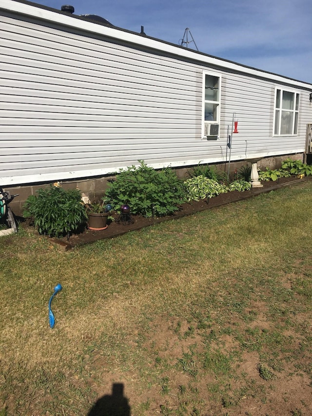 view of property exterior with cooling unit and a yard