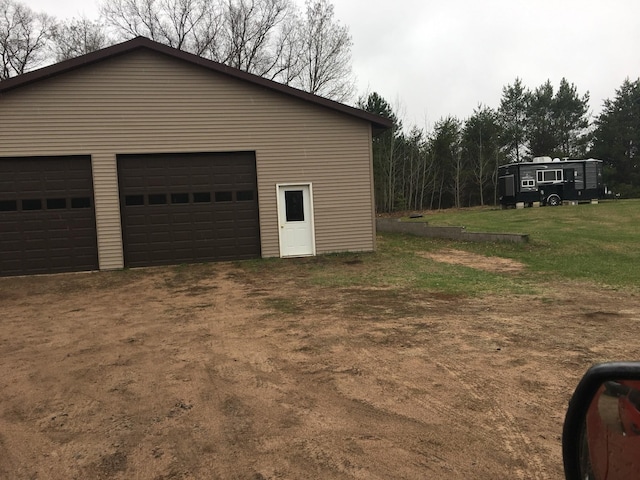 garage featuring a lawn