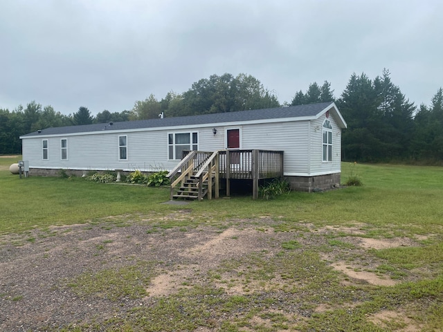 view of front facade featuring a front yard and a deck