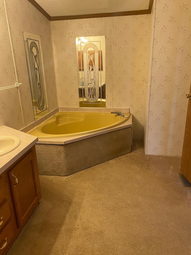 bathroom with crown molding, vanity, a bath, and a textured ceiling