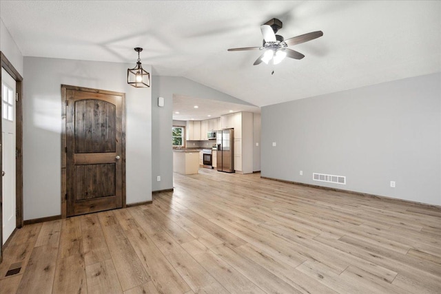 foyer entrance featuring lofted ceiling, light hardwood / wood-style flooring, and ceiling fan