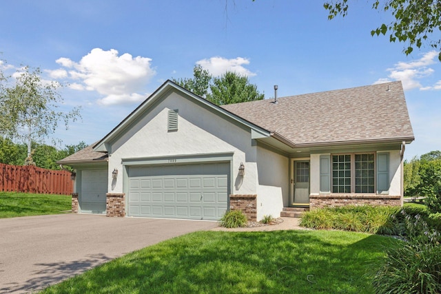 ranch-style house with a garage and a front yard