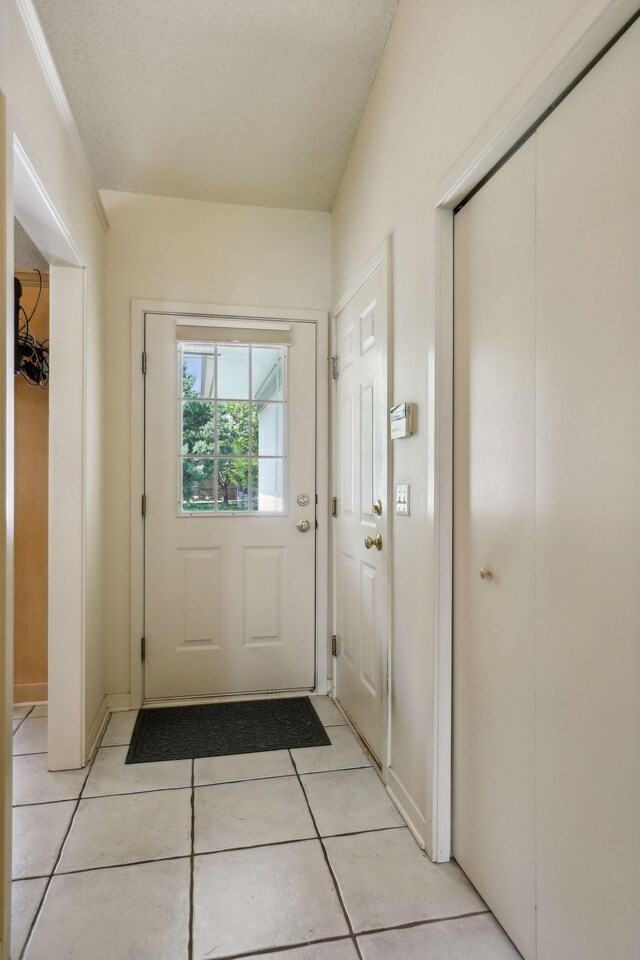 entryway featuring light tile patterned floors