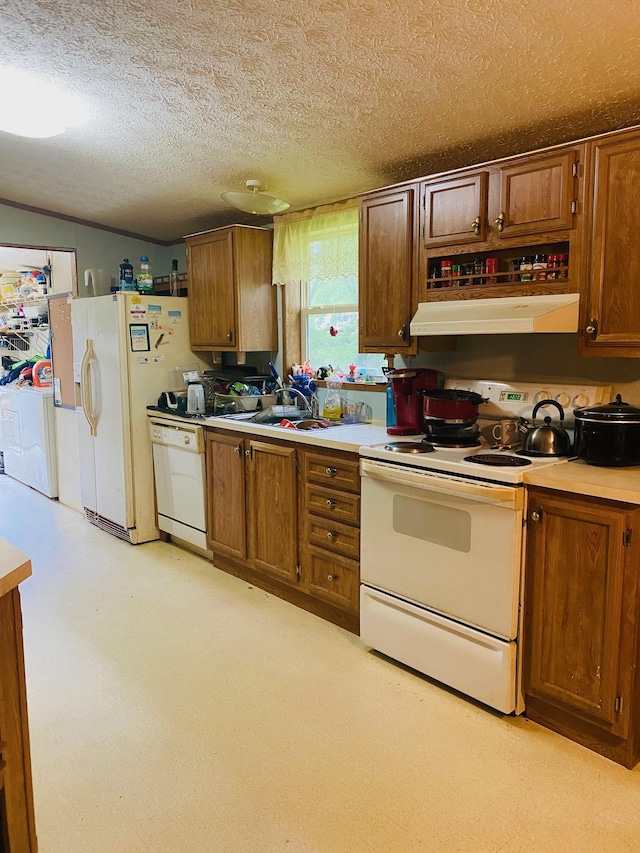 kitchen featuring a textured ceiling and white appliances