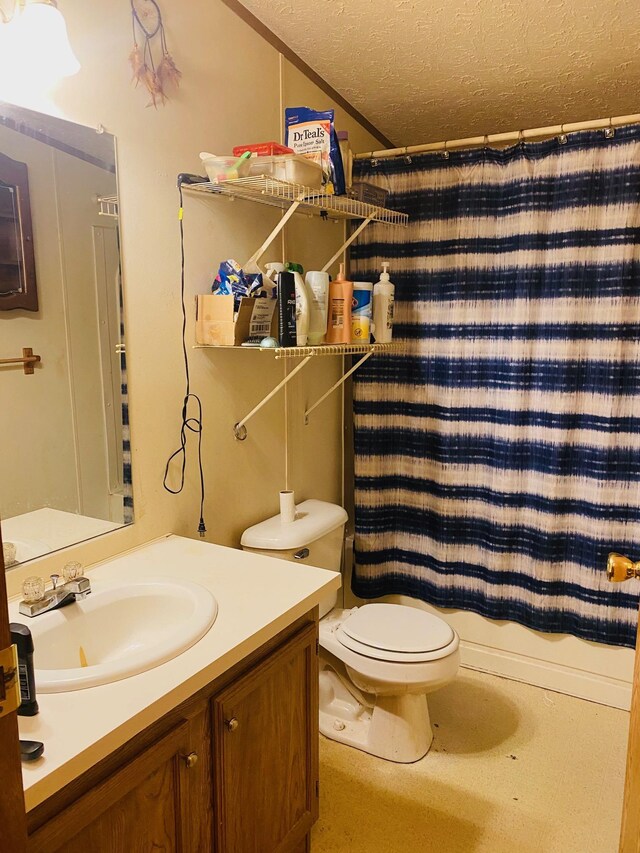 bathroom with vanity, a textured ceiling, and toilet