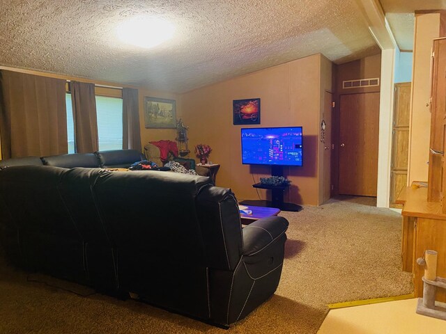 living room with vaulted ceiling, carpet floors, and a textured ceiling