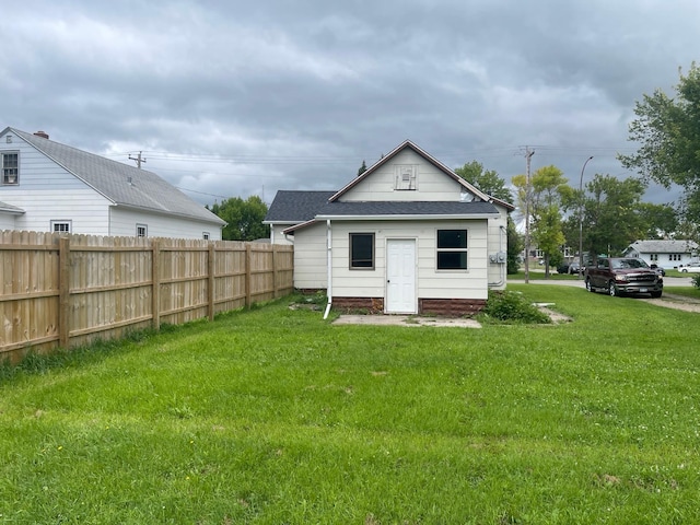 view of outbuilding featuring a lawn