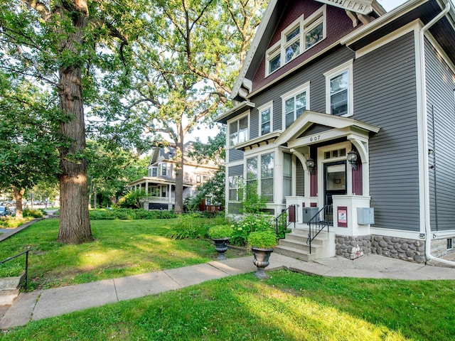 victorian home featuring a front lawn