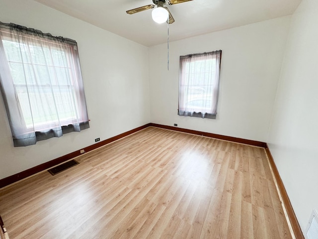 empty room with light wood-type flooring and ceiling fan