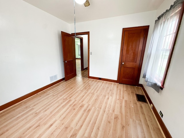 spare room with light hardwood / wood-style floors, plenty of natural light, and ceiling fan