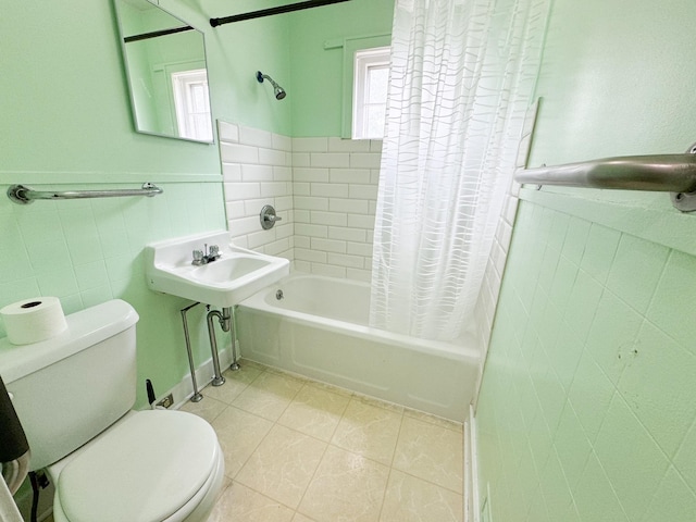 bathroom with shower / tub combo, tile patterned flooring, tile walls, and toilet