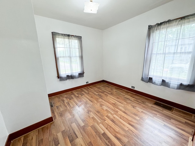 unfurnished room featuring hardwood / wood-style floors