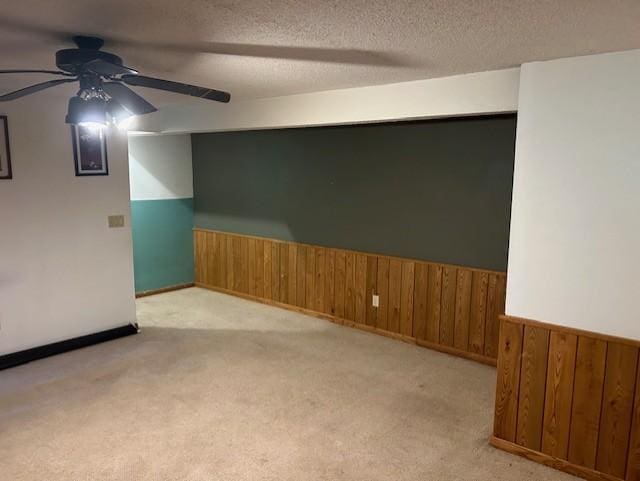 unfurnished room with light carpet, a textured ceiling, and ceiling fan