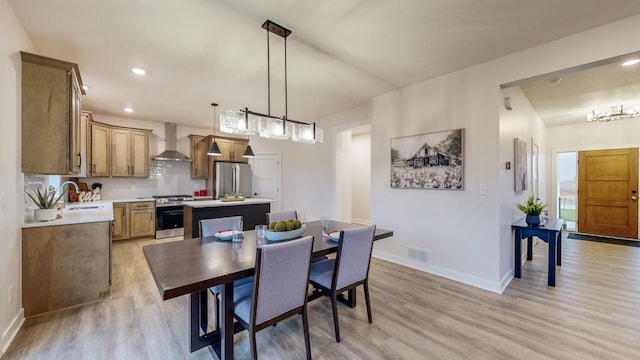 dining room with light hardwood / wood-style floors and sink